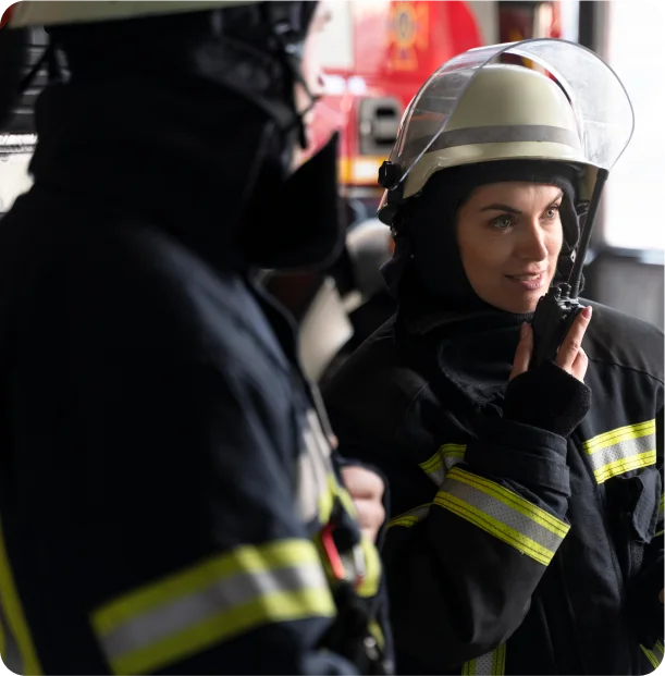 How do waking watch fire teams coordinate with emergency services?